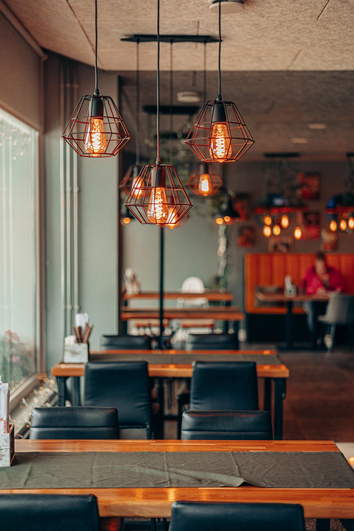 Warm rustic Georgian restaurant interior with vintage lighting and wooden tables